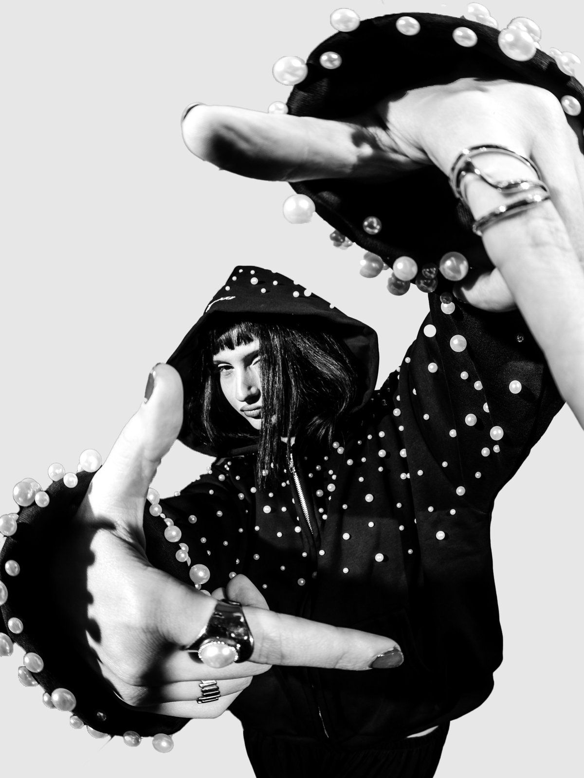 Pearl zip-up from below, a pearl sleeve reaching to the camera