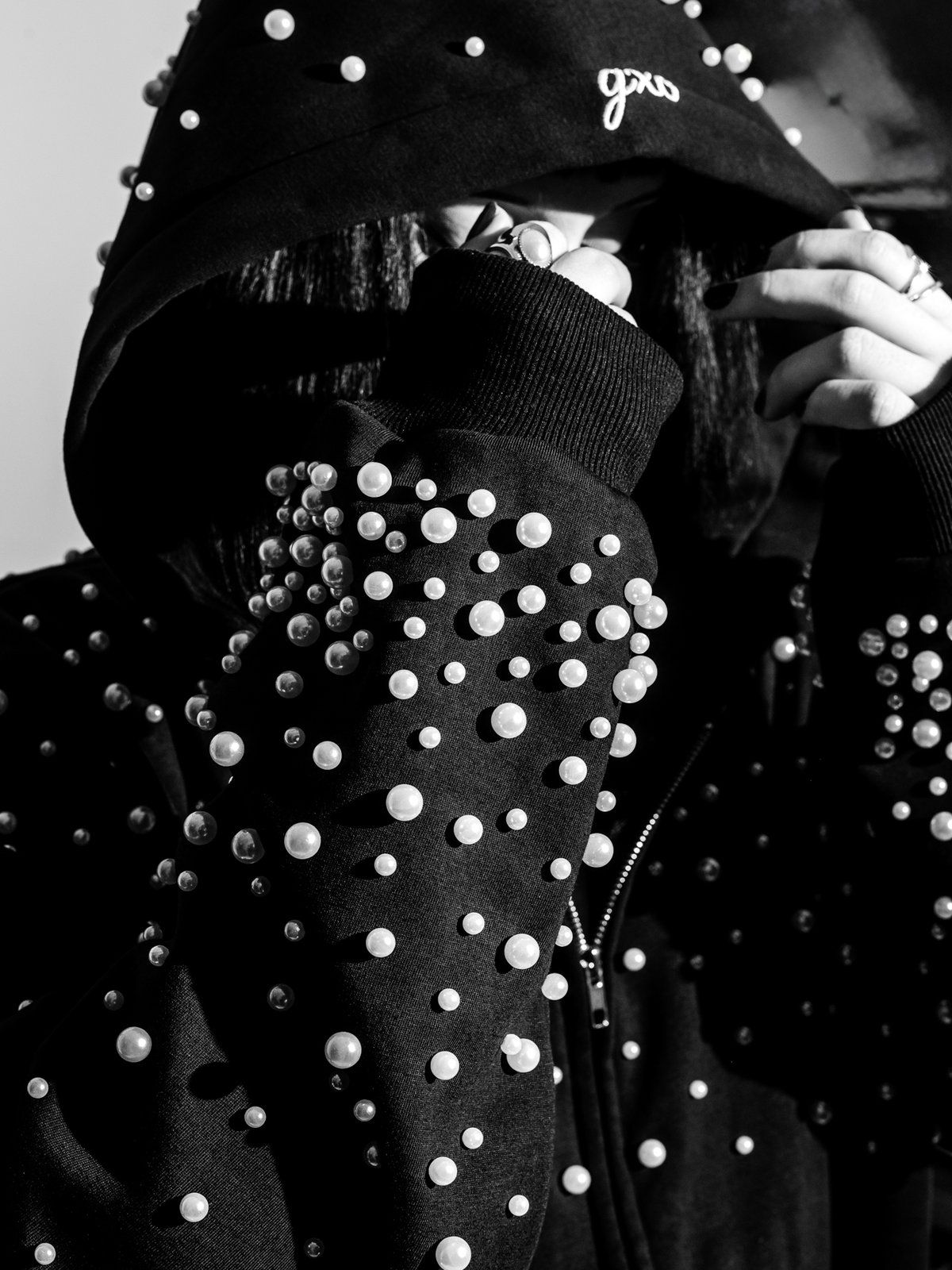 Close up of the pearl hood and sleeve, hand over the face