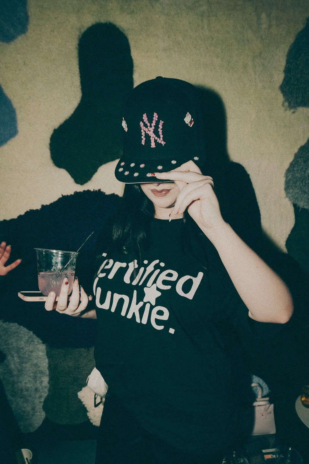 Black cap worn low at a party