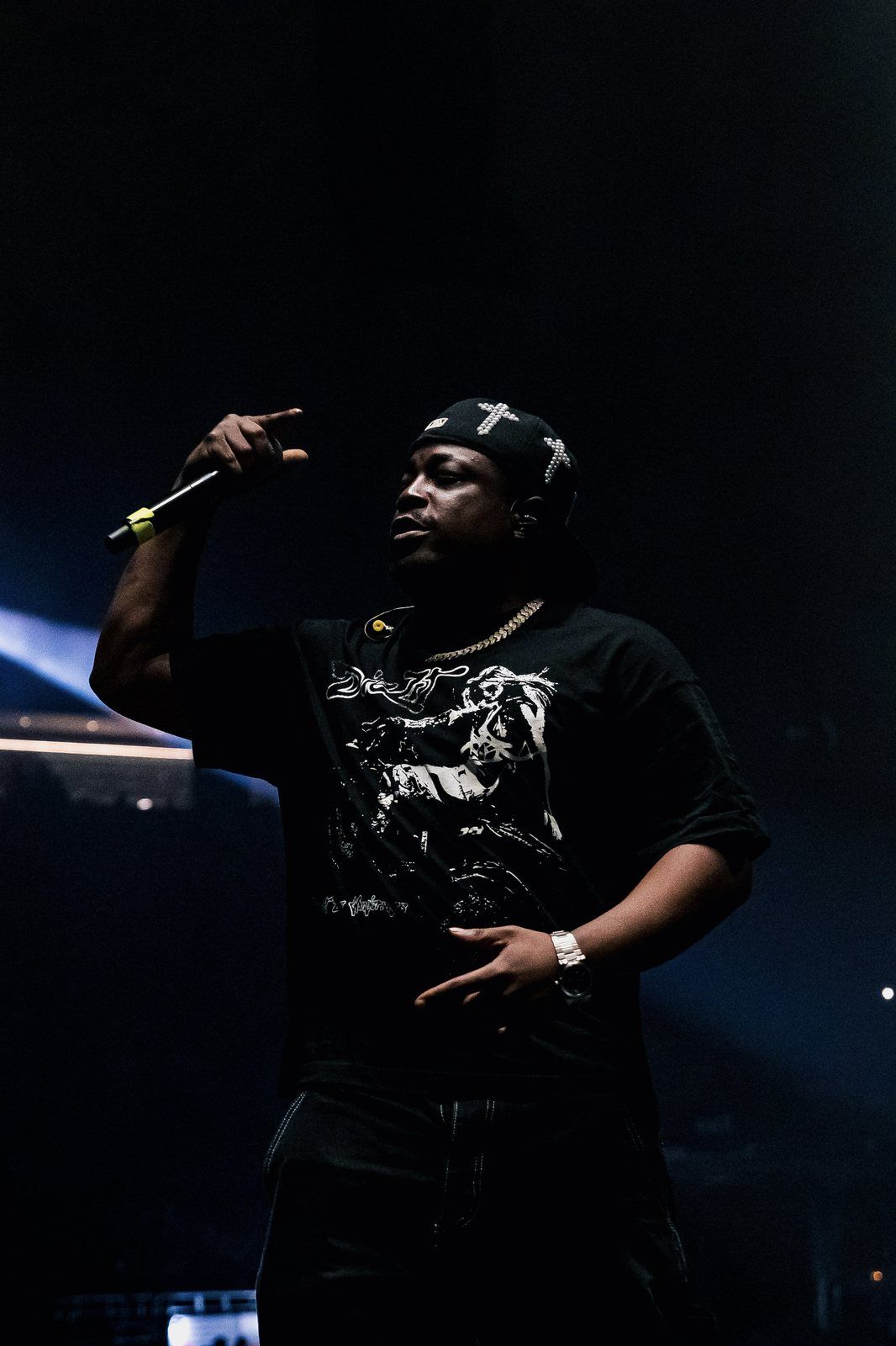 Performer in a black cap on stage