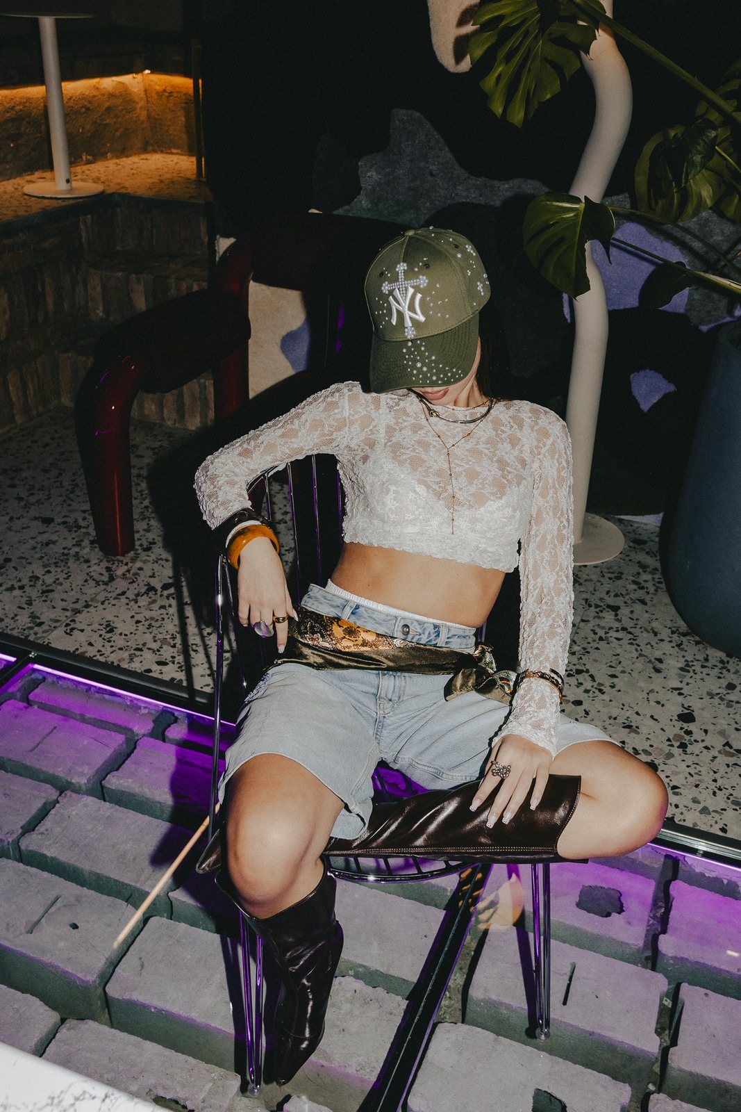 Sitting on a chair in an olive cap