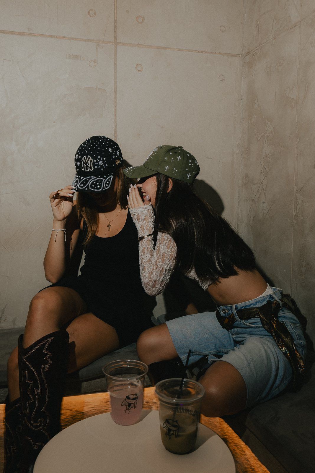 Two friends at a table in the caps