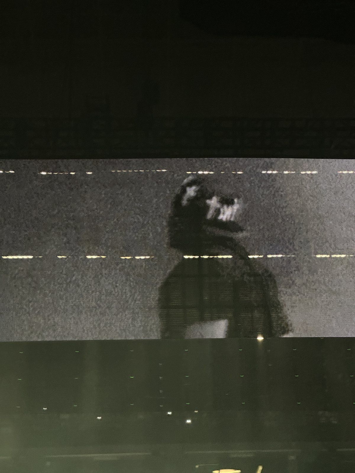 Performer in a black cap on the big screen