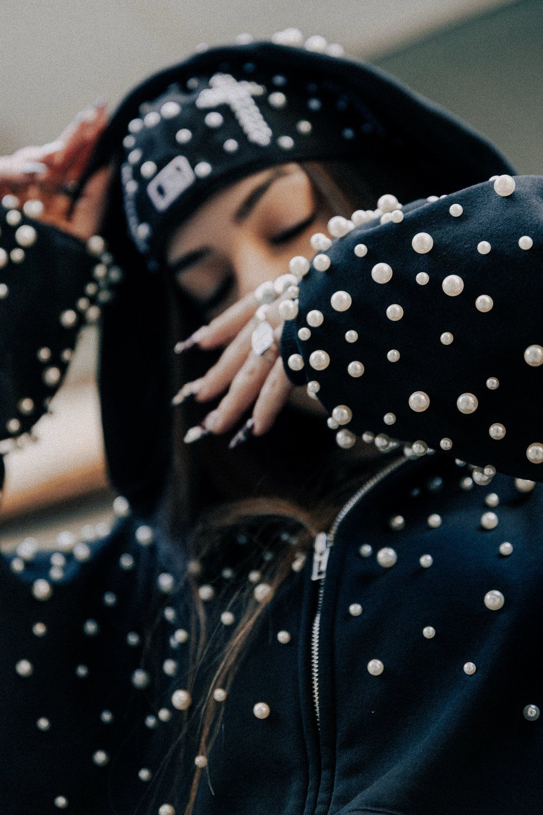 Close up of the pearl sleeves and hood of the zip-up